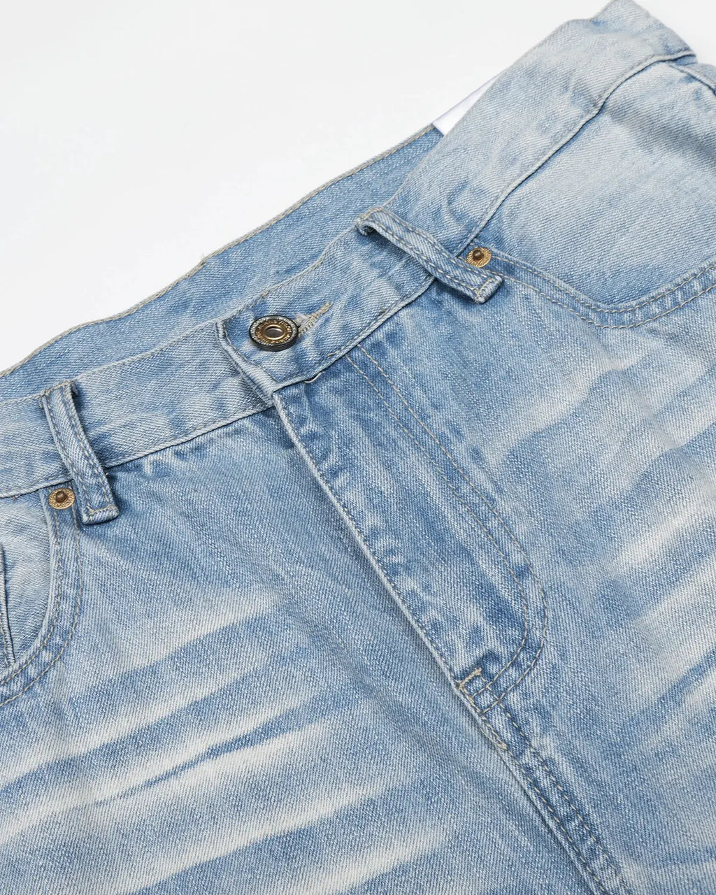 Vintage whiskered bootcut jeans from INFLATION Streetwear with faded wash and classic fit, shown hanging on a white background.