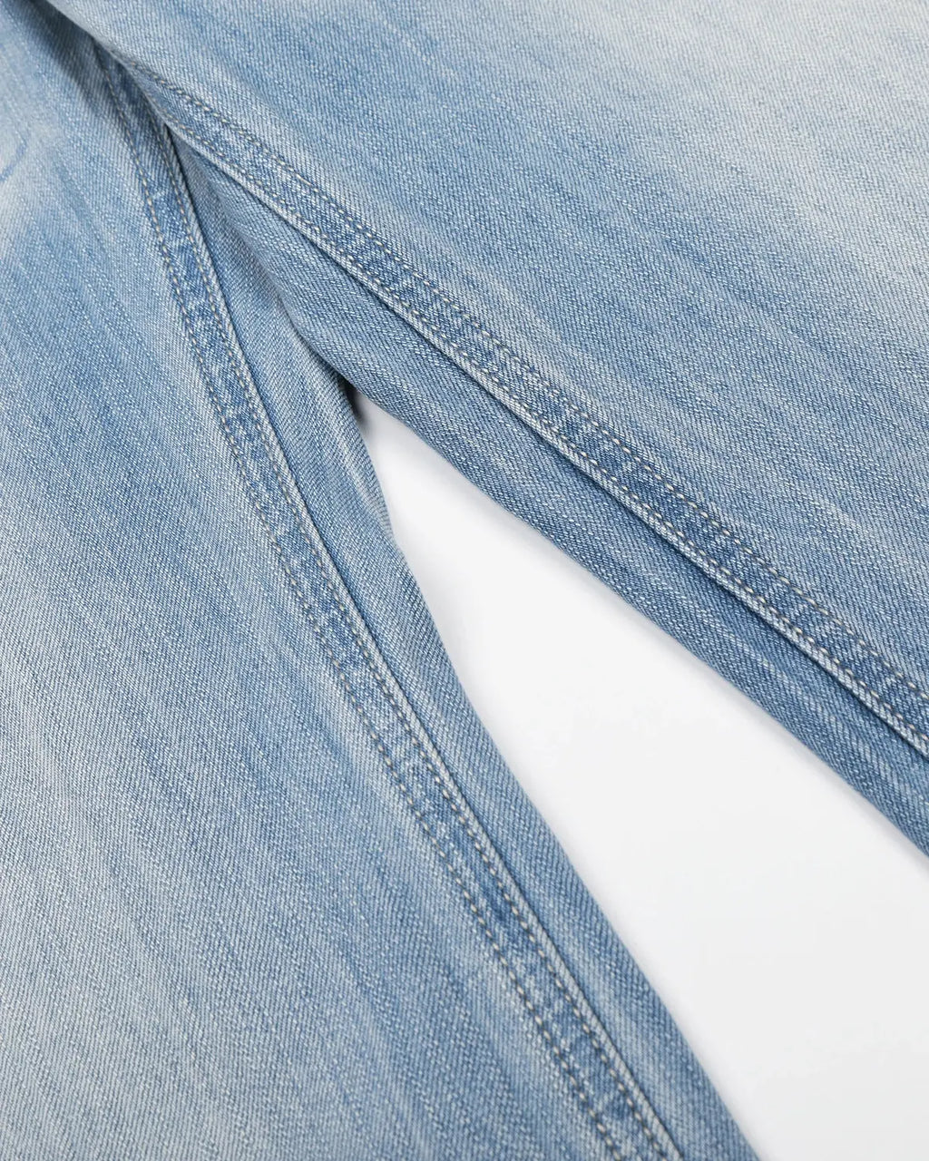 Vintage whiskered bootcut jeans by INFLATION Streetwear, showing distressed denim with fading and classic leg silhouette.