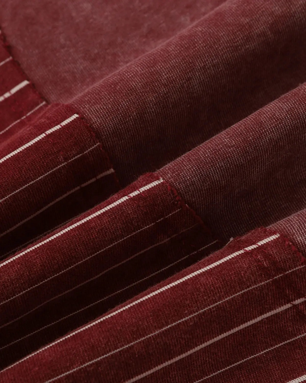 Inflation Streetwear striped patchwork washed T-shirt with multicolor design and casual fit, displayed on a hanger.