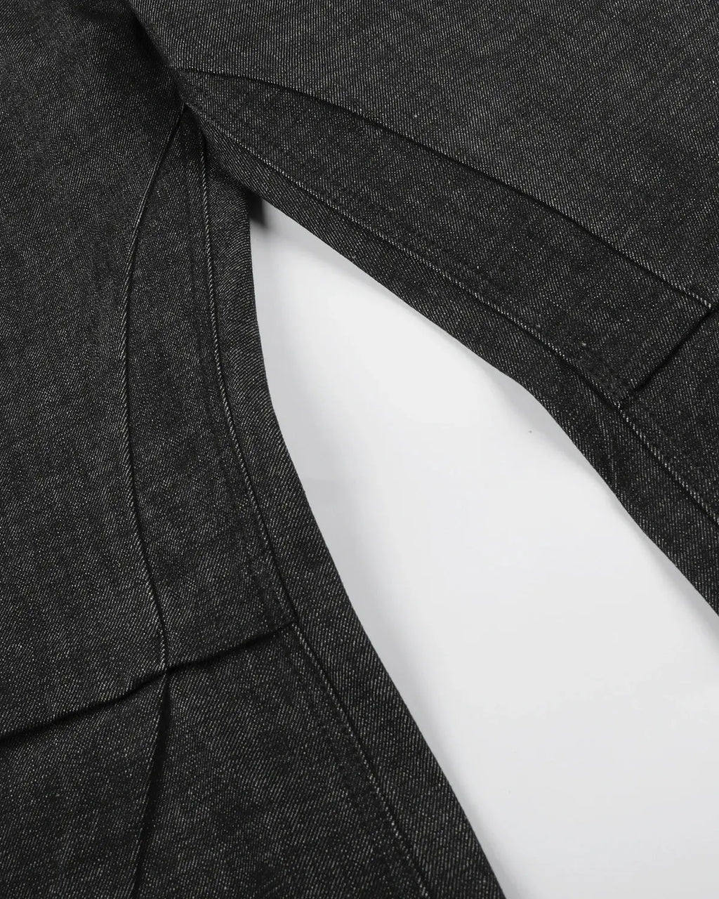 Button detail deconstructed raw baggy jeans by INFLATION, featuring relaxed fit and distressed raw denim with unique button accents.
