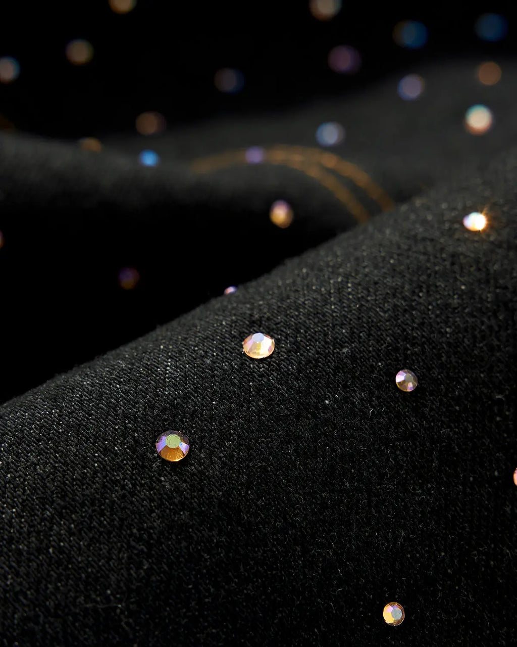 Colorful rhinestone raw barrel jeans by Flation Streetwear featuring vibrant embellishments and distressed denim detail.