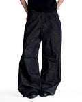 Cinch back raw baggy jeans by INFLATION featuring a relaxed fit, raw denim, and streetwear style with adjustable waist detail.