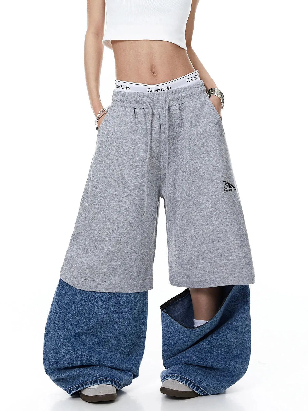 Denim detachable patchwork barrel joggers from Inflation Streetwear with distressed and patched design, relaxed fit, and cuffed ankles.