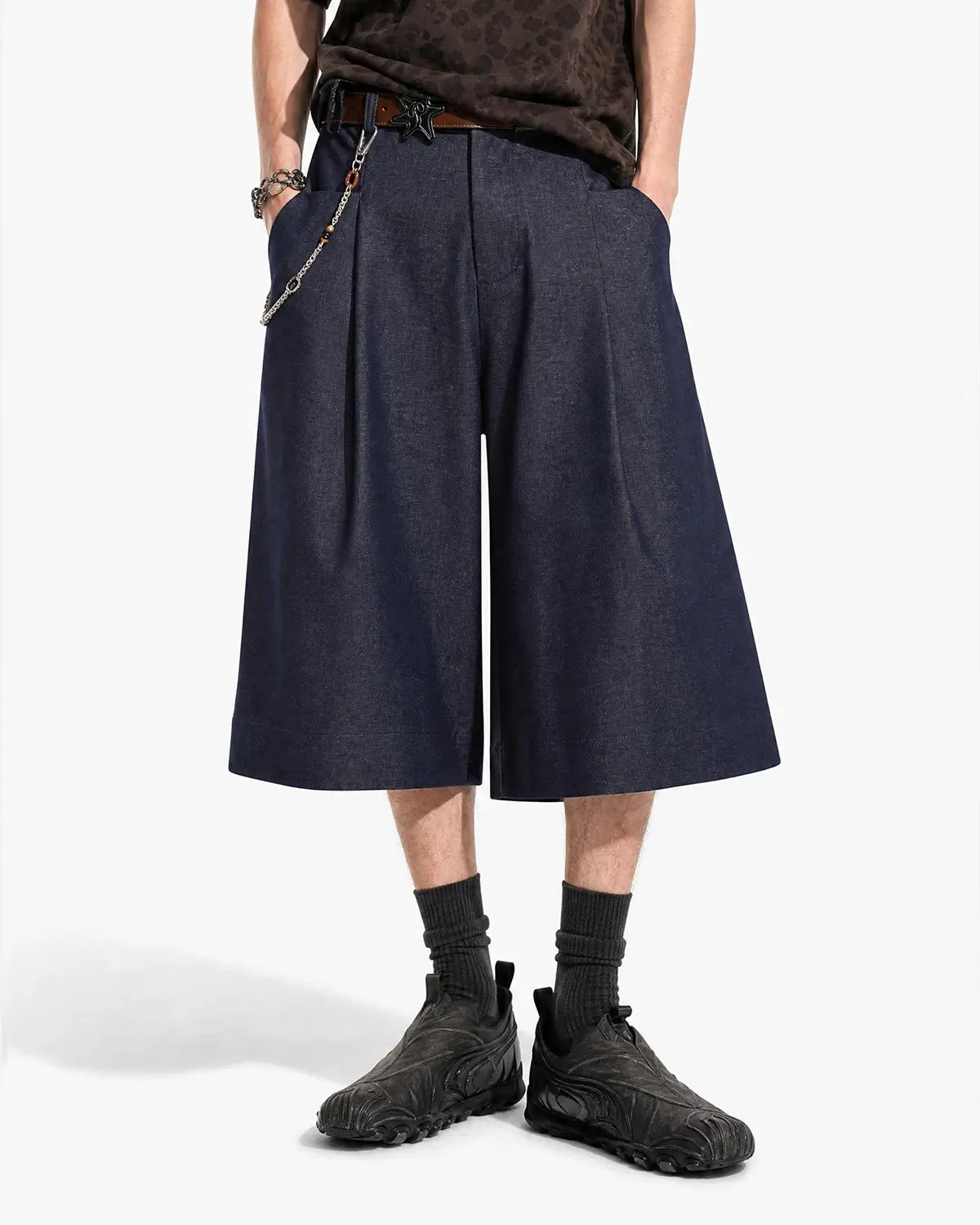 Inflation Streetwear pleated wide-leg tailored shorts with a high waist and relaxed fit, shown on a model.
