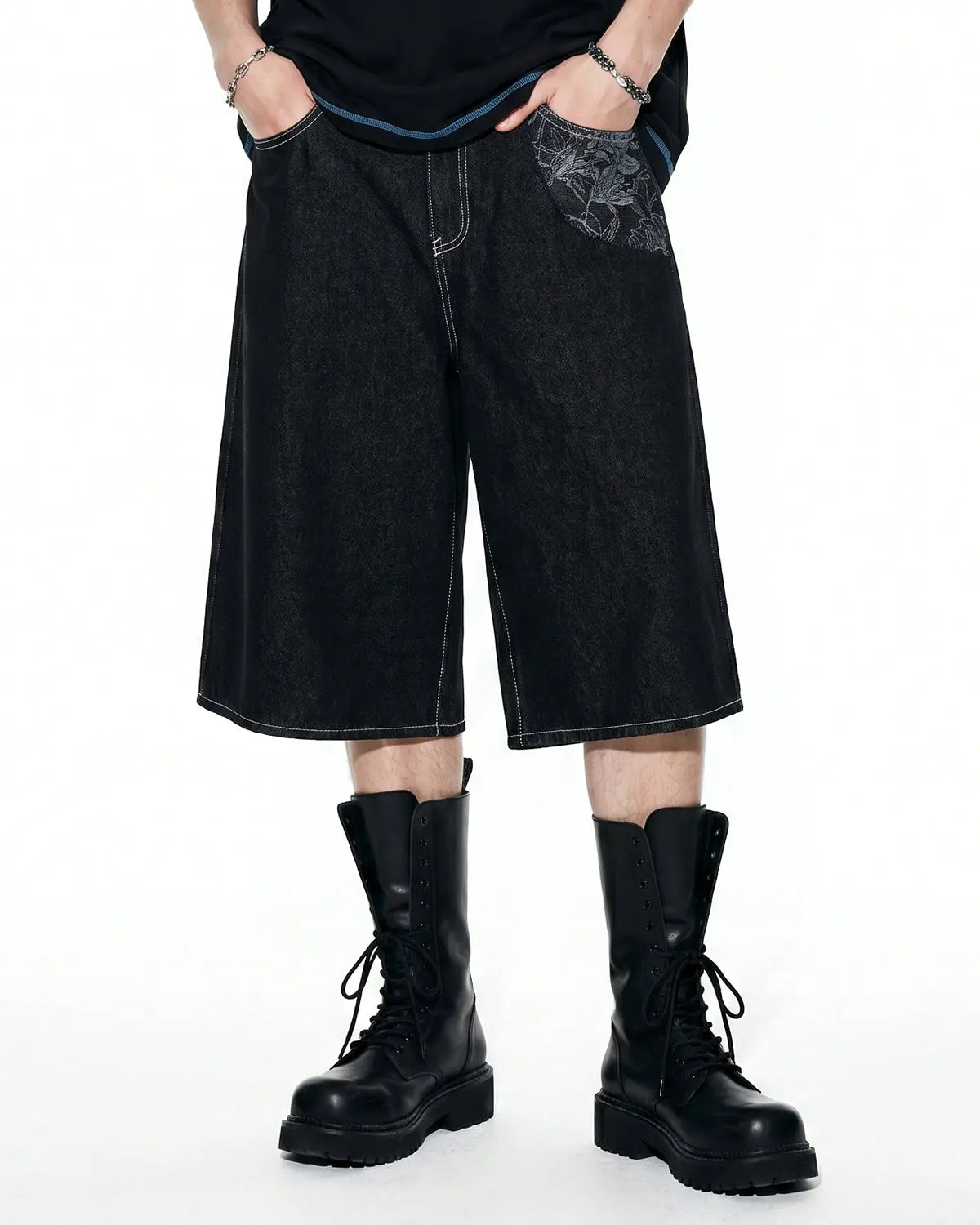Baggy denim jorts with embroidered pocket from INFLATION streetwear, showcasing relaxed fit and detailed embroidery on the pocket.