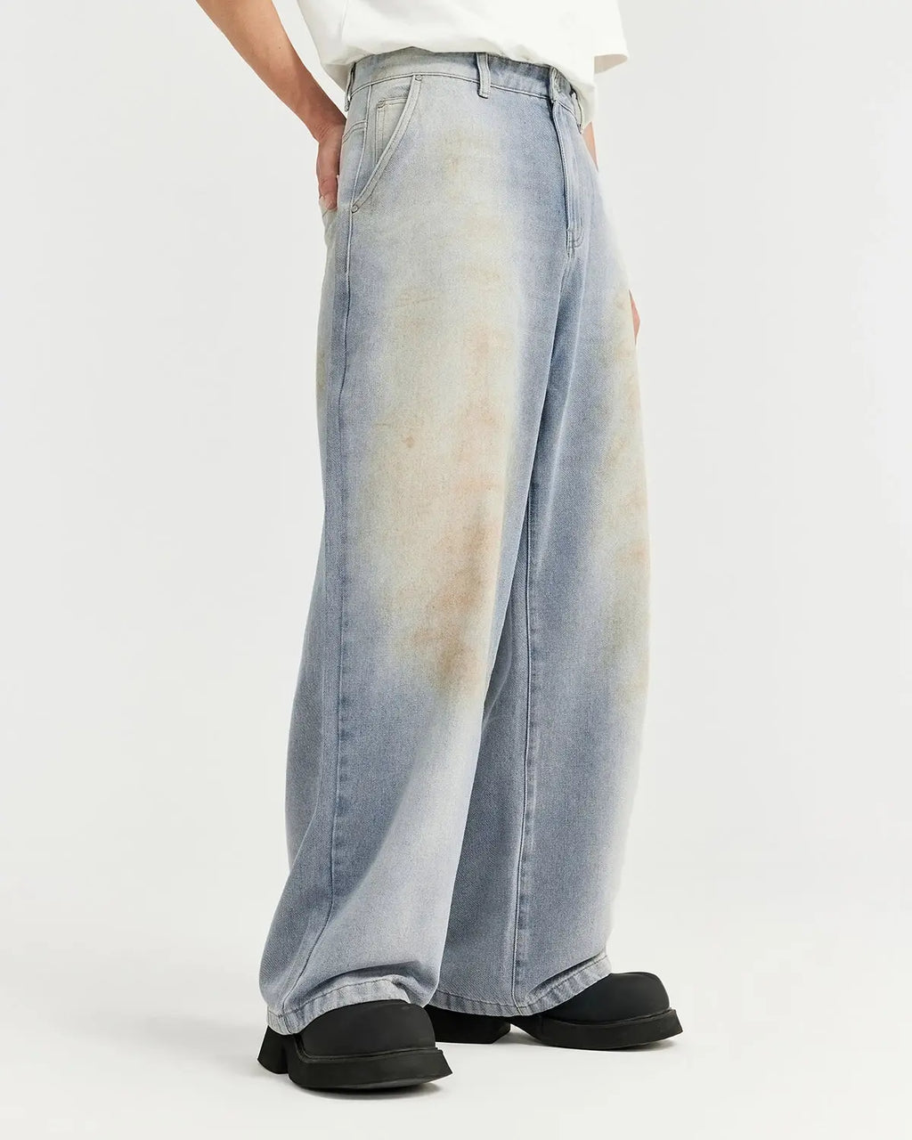 Mud washed baggy jeans by Flation, featuring a relaxed fit, distressed details, and a casual streetwear style.