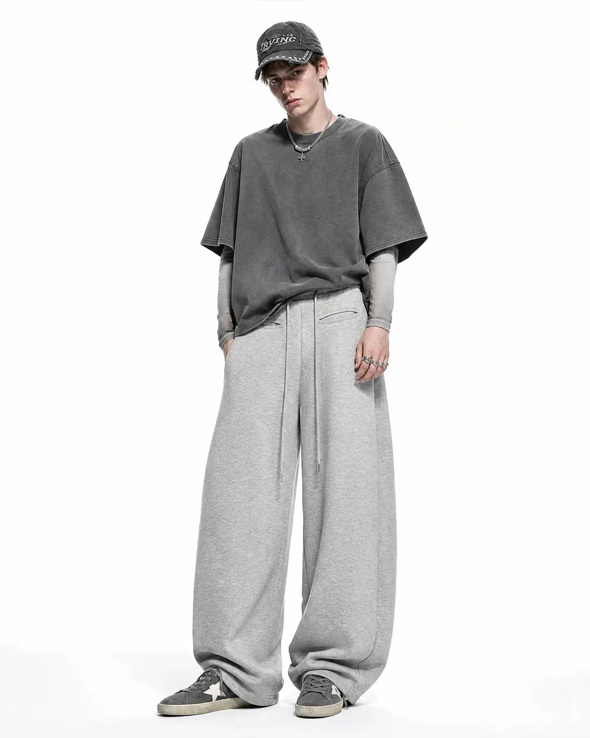 Inflation Streetwear curved wide-leg sweatpants in soft fabric, shown on a model with a relaxed fit and elastic waistband.