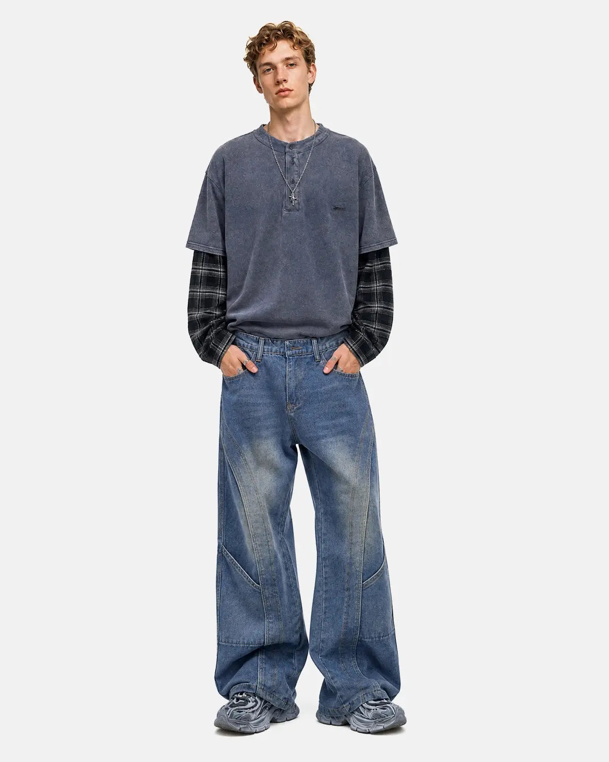 Deconstructed baggy straight-leg jeans from Inflation Streetwear, featuring distressed details and relaxed fit in denim.