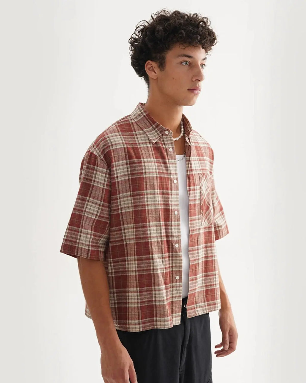 Flation boxy fit plaid shirt with a classic red and black checkered pattern, long sleeves, and collar, casual streetwear style.
