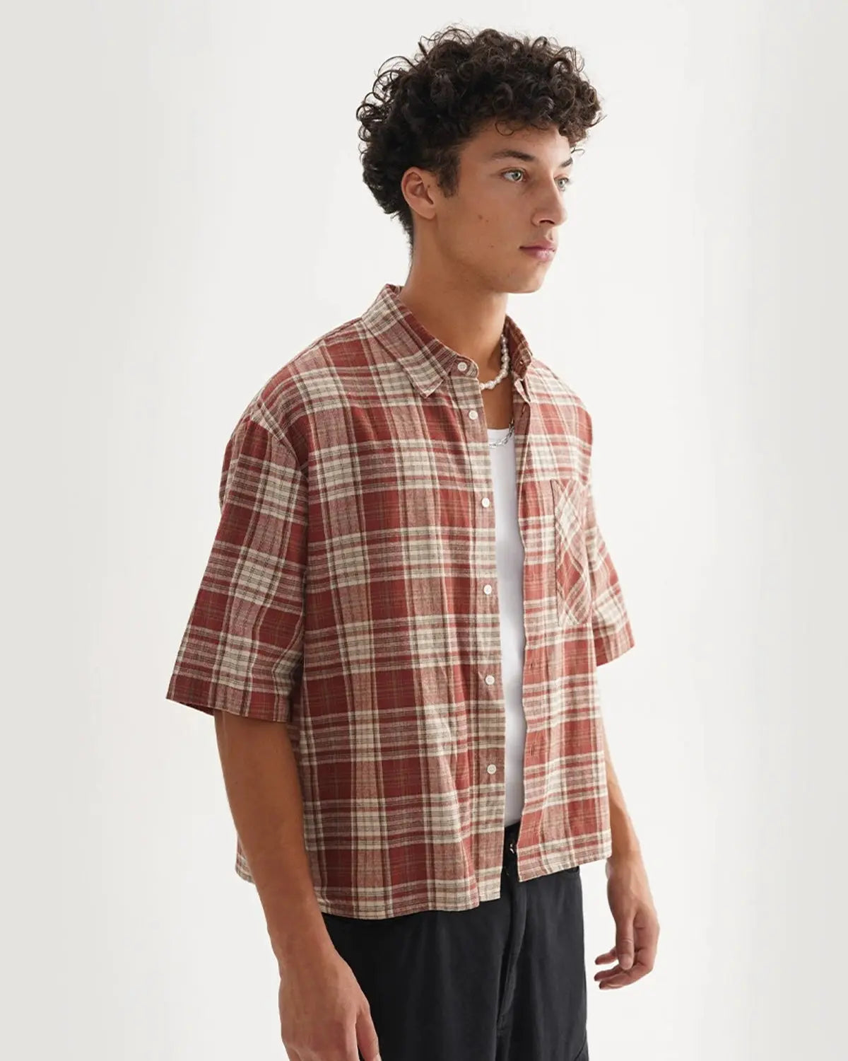 Flation boxy fit plaid shirt with a classic red and black checkered pattern, long sleeves, and collar, casual streetwear style.