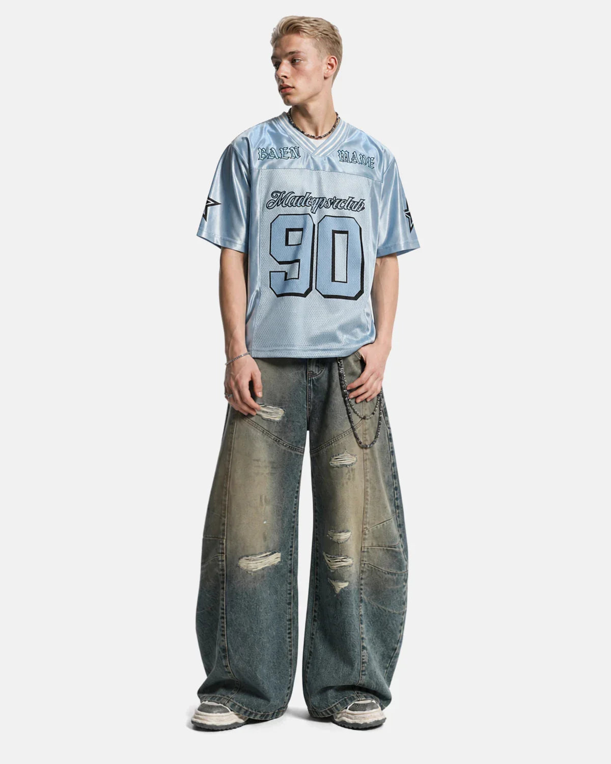 Pair of distressed dirty wash barrel jeans by INFLATION, showcasing a rugged, worn-in denim look with fading and distressed details.
