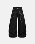 Metal eyelet chain barrel jeans by INFLATION with distressed denim and metal embellishments, styled with a relaxed streetwear look.