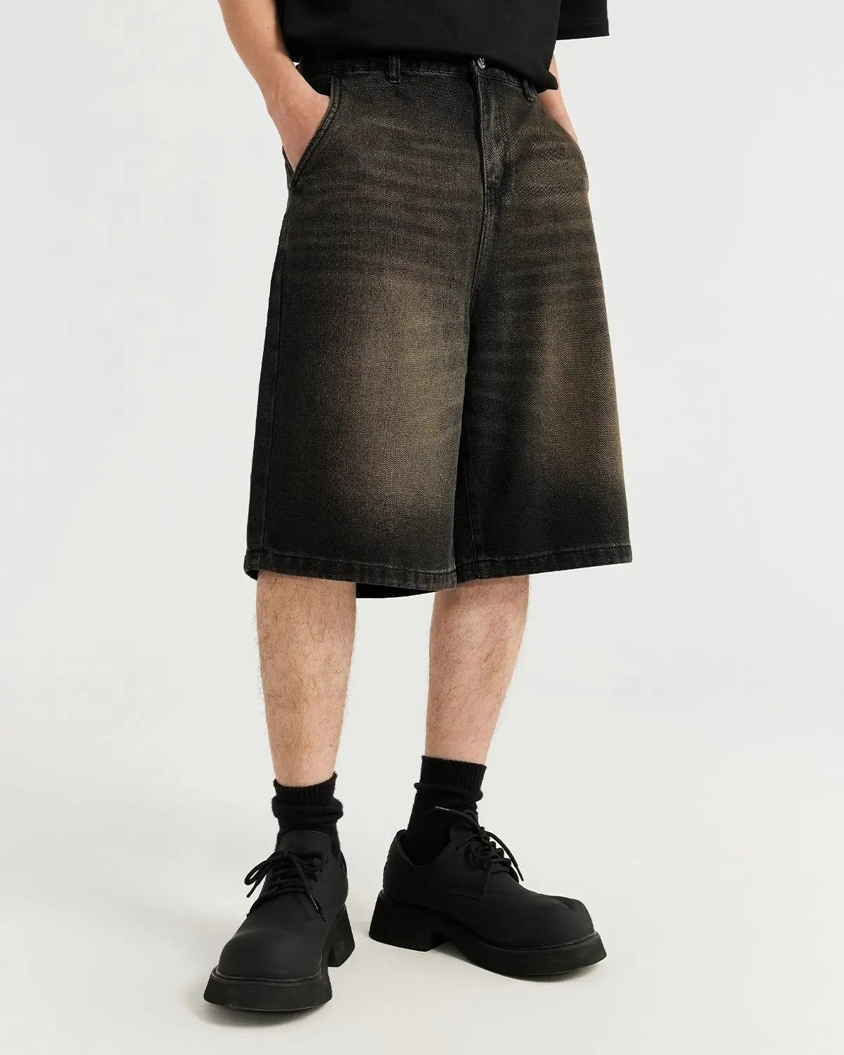 Retro washed jeans jorts by INFLATION, featuring distressed denim and a casual streetwear style, displayed on a model.