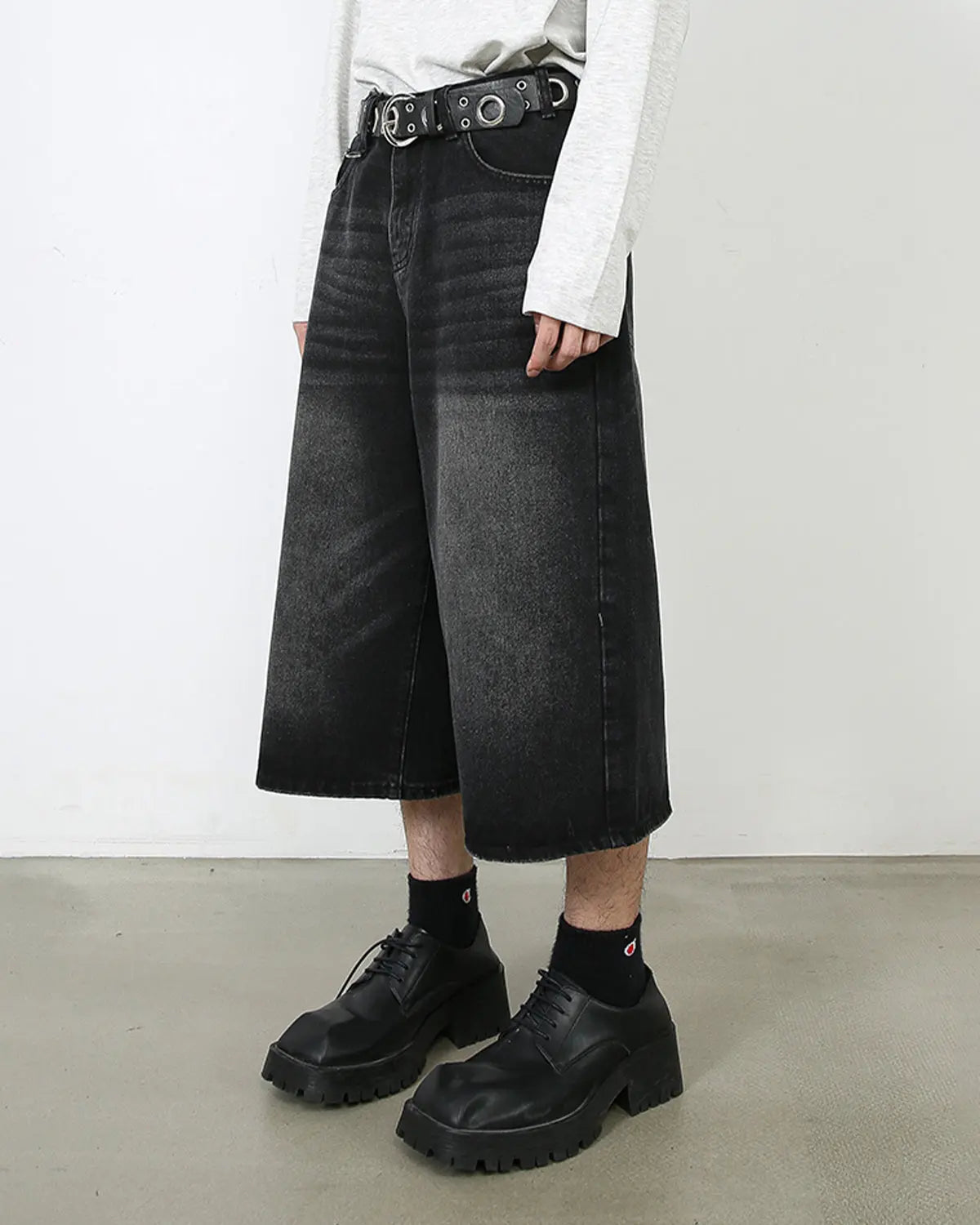 Washed baggy denim jorts by INFLATION, streetwear style, featuring a relaxed fit, distressed details, and casual denim fabric.