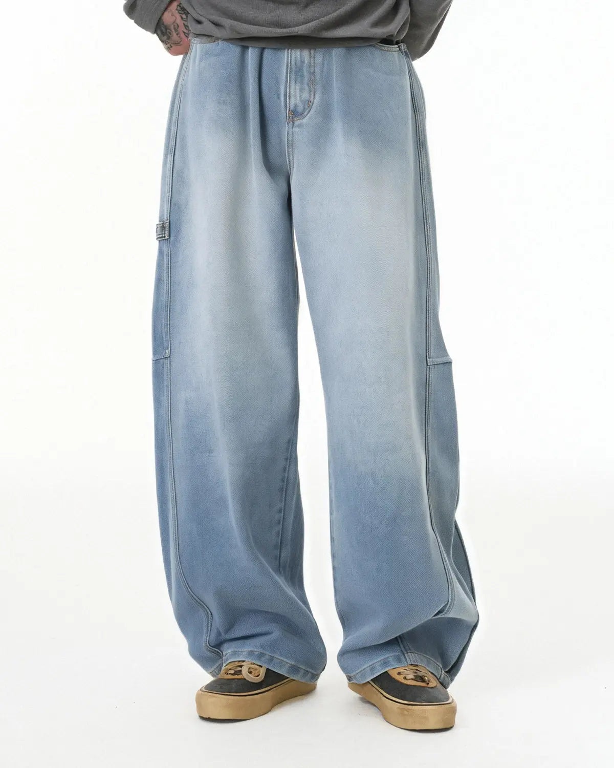 Distressed baggy cargo jeans by Flation featuring a relaxed fit, multiple pockets, and a distressed denim design.