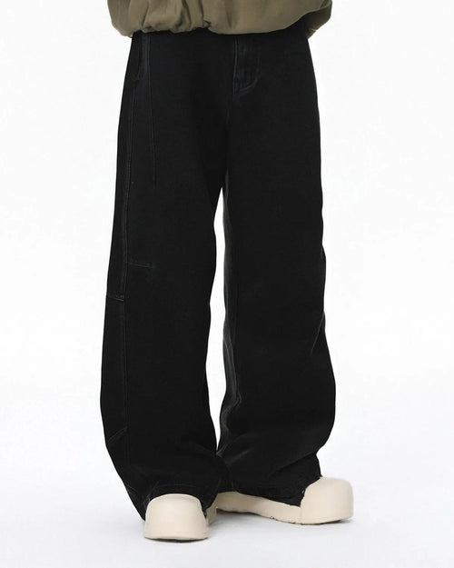Acid washed black barrel jeans by Flation Streetwear with a relaxed fit and distressed finish, showcasing the textured denim fabric.