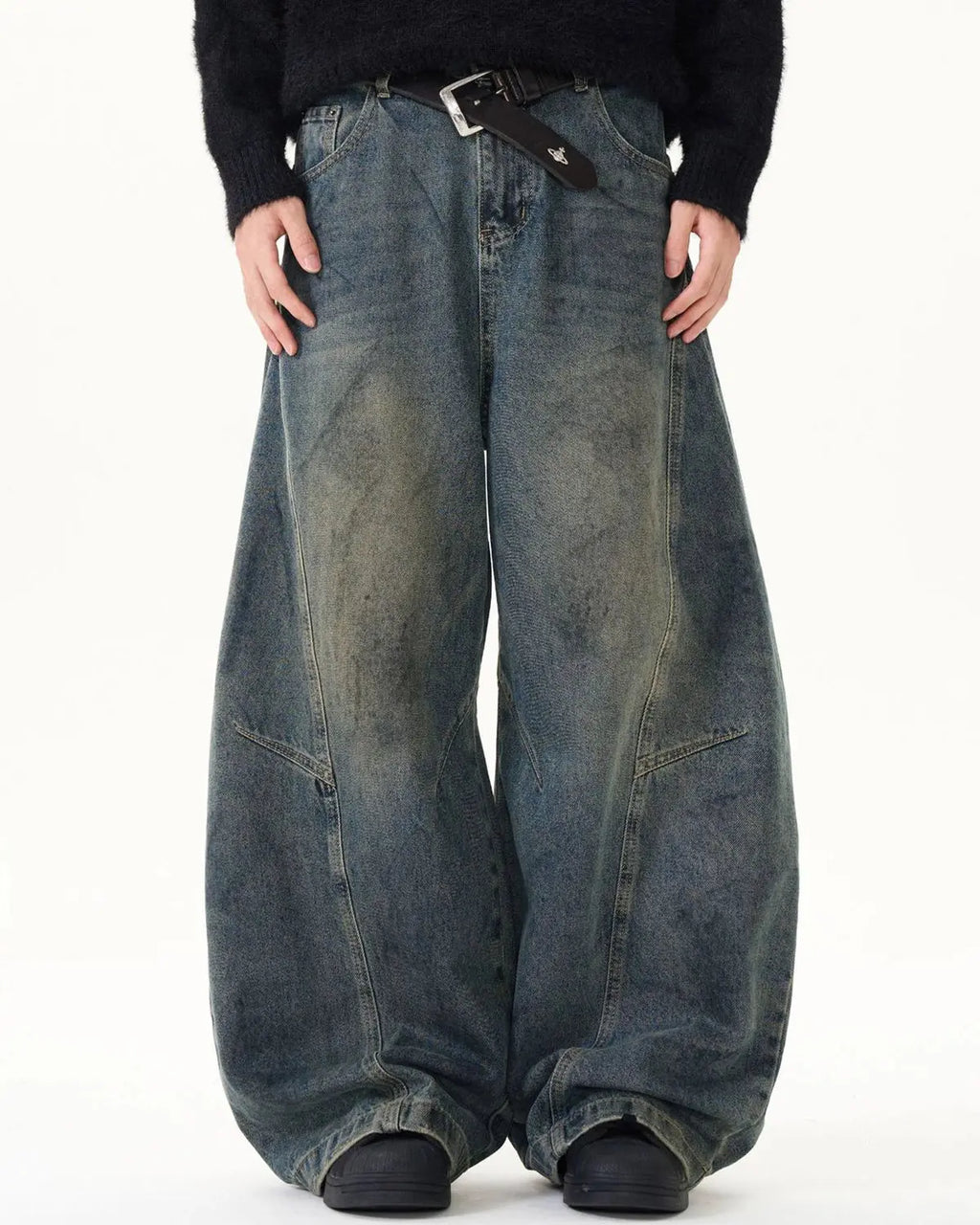 Washed deconstructed barrel jeans by Inflation Streetwear featuring distressed details and relaxed fit, shown on a model.