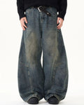 Washed deconstructed barrel jeans by Inflation Streetwear featuring distressed details and relaxed fit, shown on a model.