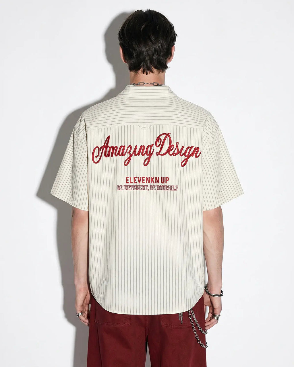 Striped embroidered short-sleeve shirt from INFLATION Streetwear featuring colorful vertical stripes and detailed embroidery.
