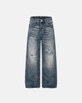 Distressed Baggy Jeans from Whisker Wash by INFLATION Streetwear, showcasing relaxed fit with ripped details and casual style.