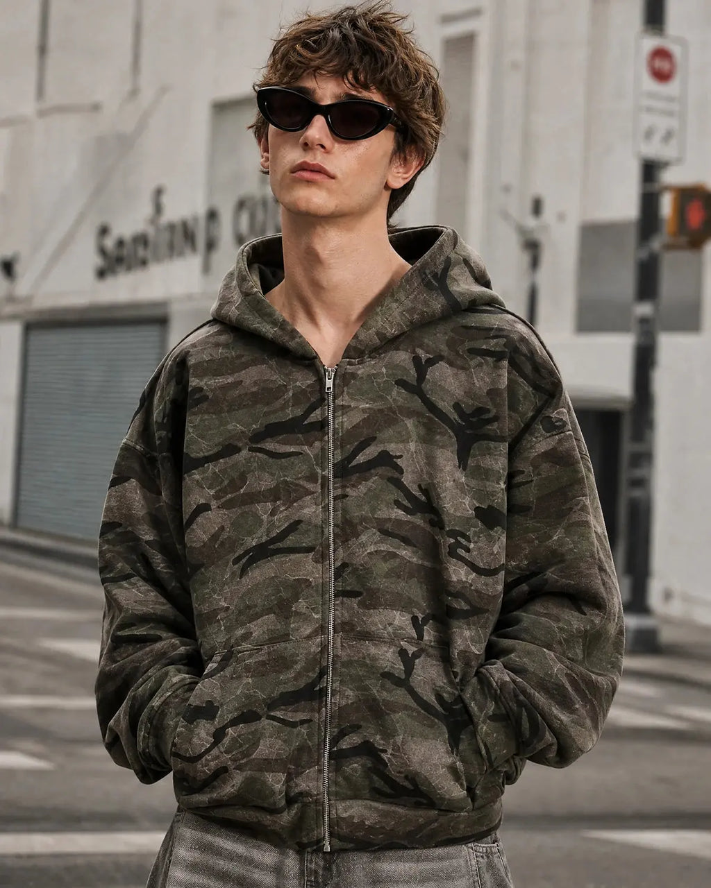 Camouflage zip-up jacket by Flation Streetwear featuring a green and brown camo pattern and a front zipper.