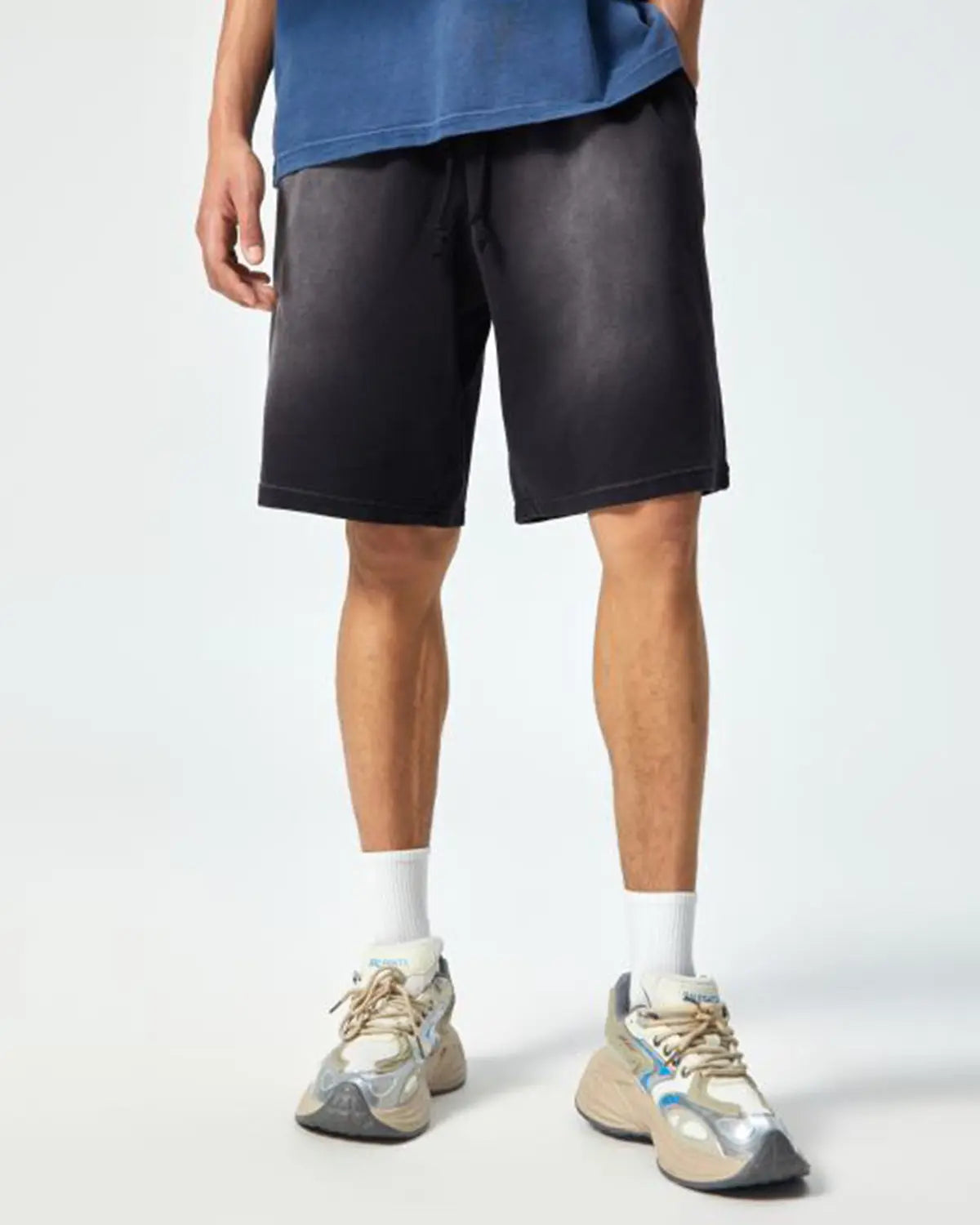 Inflation Monkey Washed Sweat Shorts displayed on a hanger, showing their relaxed fit and washed denim texture.