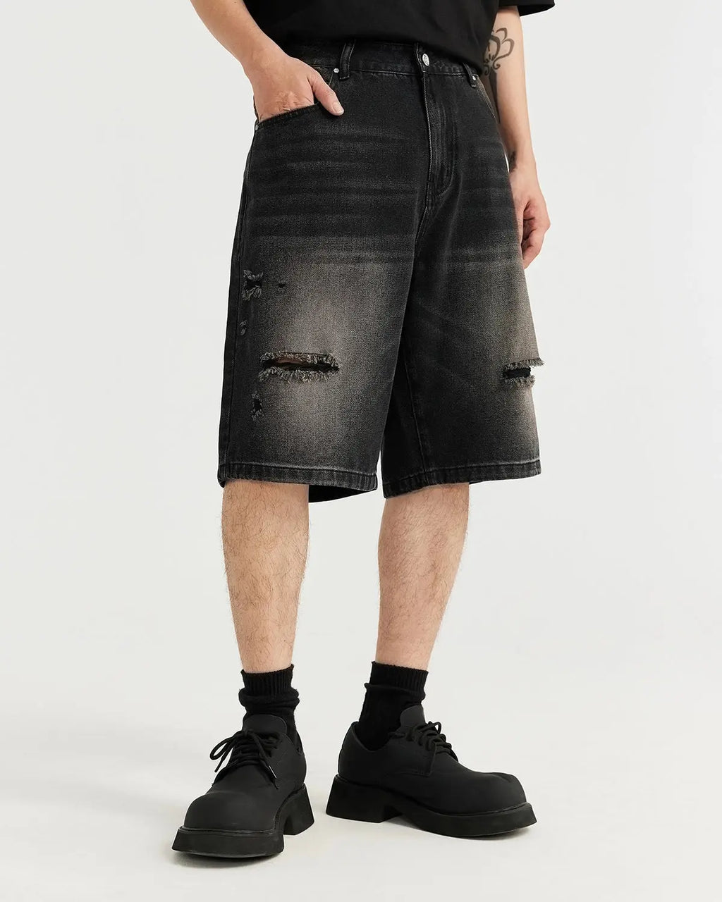 Vintage ripped washed denim jorts by Flation Streetwear, showing distressed denim shorts with frayed hems and a casual fit.