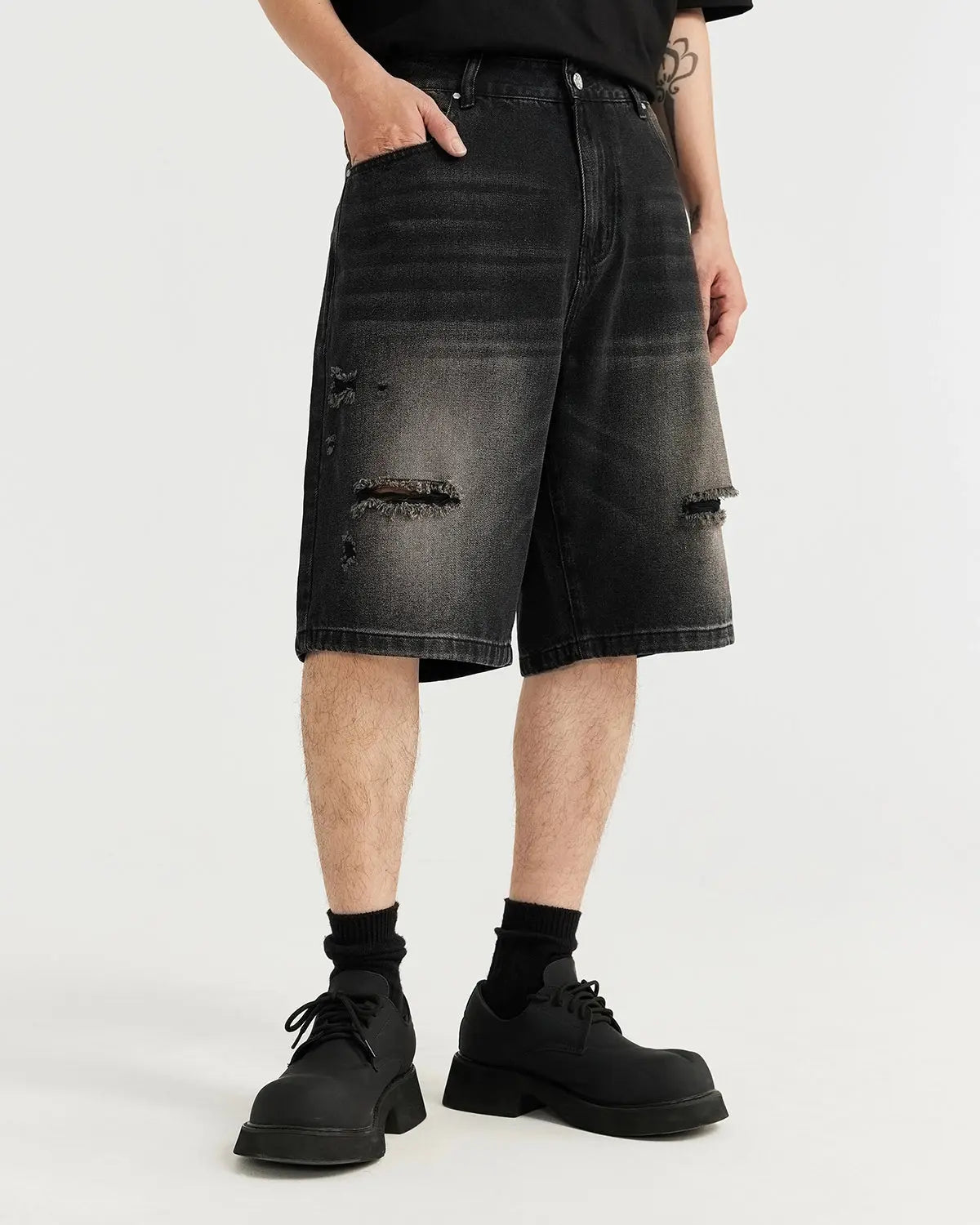 Vintage ripped washed denim jorts by Flation Streetwear, showing distressed denim shorts with frayed hems and a casual fit.