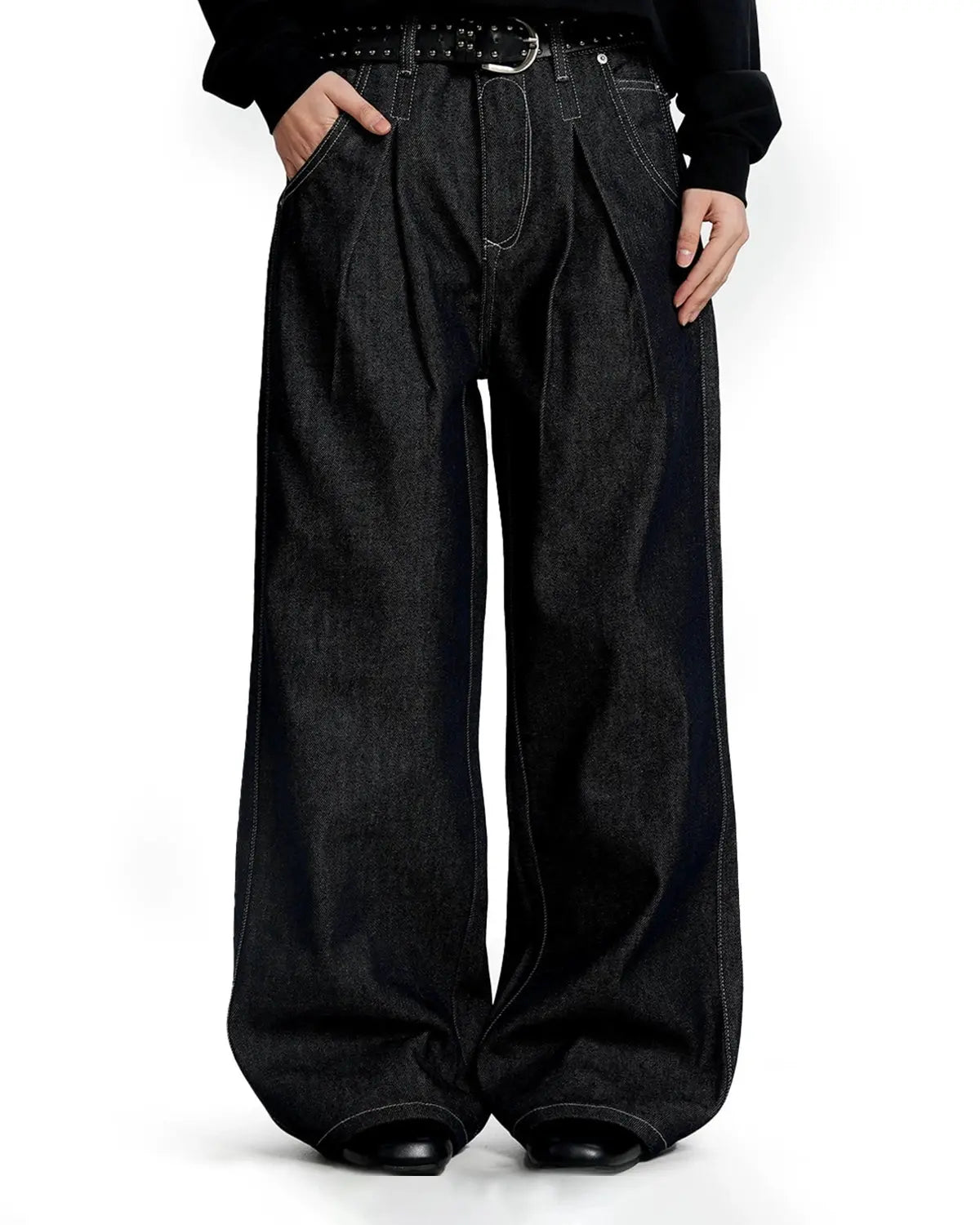 Raw baggy jeans with contrast stitching by INFLATION Streetwear, showcasing relaxed fit and detailed stitching on denim fabric.
