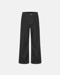 Deconstructed raw denim bootcut jeans by INFLATION with visible stitching and distressed details, styled for streetwear fashion.