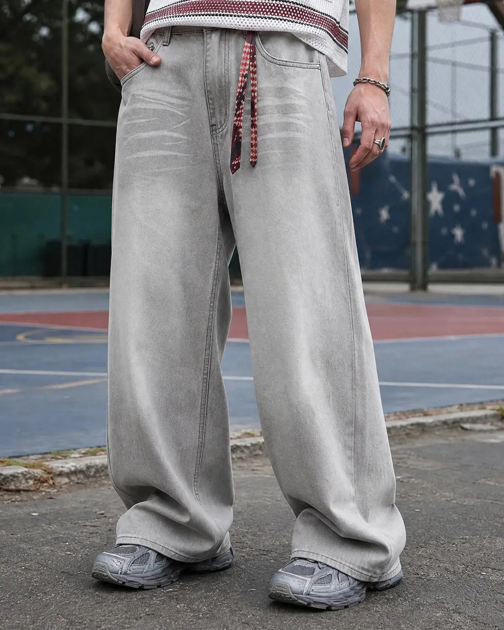 Washed distressed baggy jeans by Flation Streetwear featuring a relaxed fit and faded, ripped details on denim.