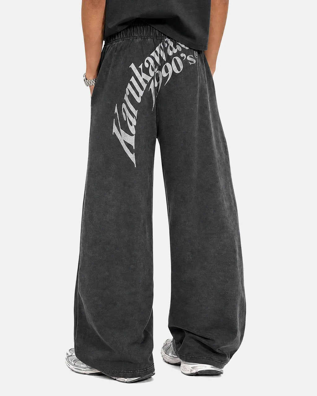 Washed graphic wide-leg sweatpants by INFLATION featuring relaxed fit, bold graphic design, and comfortable cotton fabric.