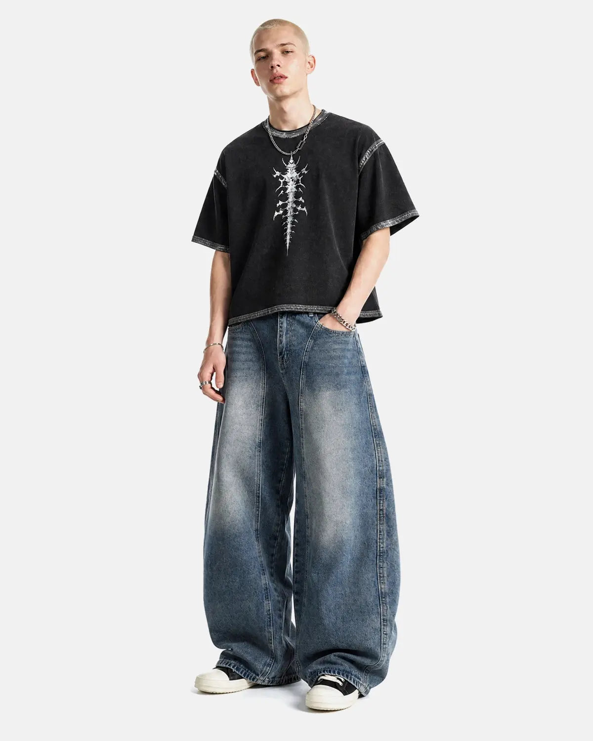 Deconstructed Barrel Jeans by INFLATION, stylish streetwear pants with unique distressed detailing and relaxed fit.