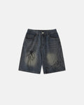Flation Spider straight leg jorts, denim pants with distressed details and a relaxed fit, displayed on a hanger.
