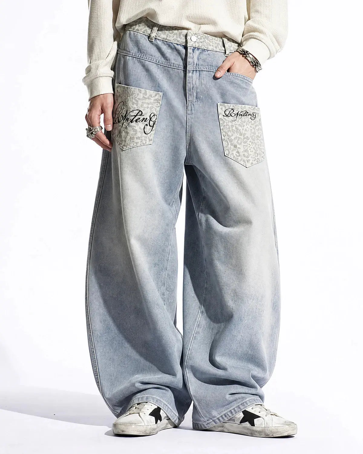 Leopard patch barrel jeans by INFLATION featuring a stylish streetwear design with leopard print patches and a relaxed fit.