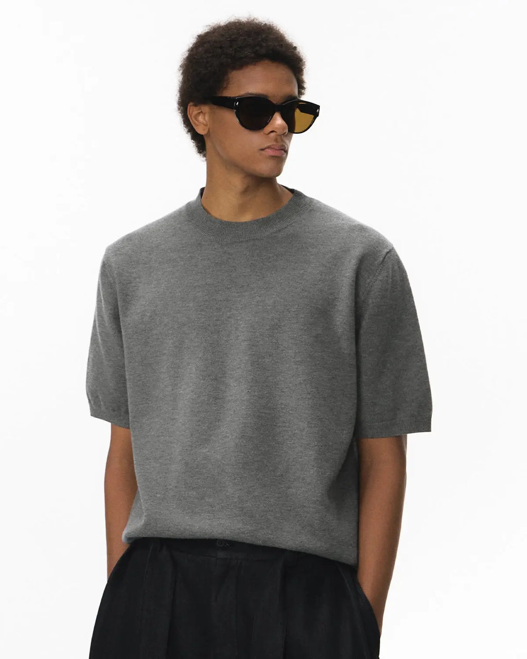 Short-sleeved crewneck sweater by INFLATION, featuring knitwear texture and casual streetwear style in a neutral color.