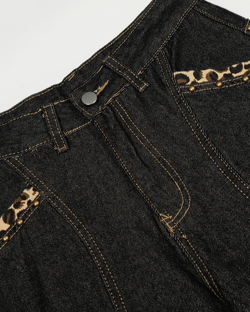 Gothic cross embroidery on blue barrel jeans by INFLATION, stylish streetwear denim with dark gothic design details.