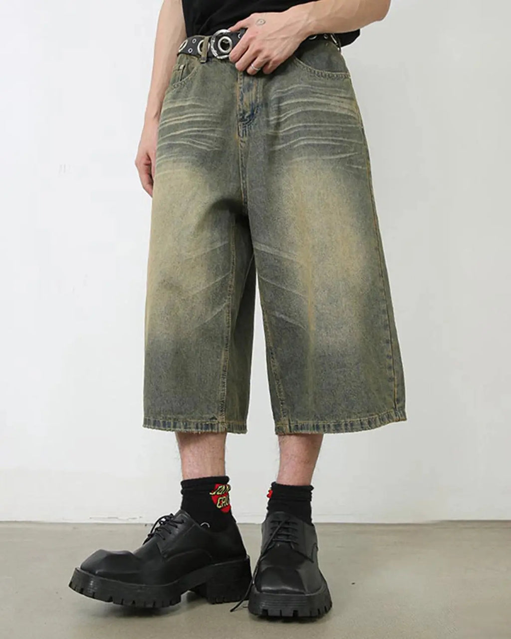 Baggy jumbo jorts by Flation Streetwear featuring distressed denim and a loose, oversized fit, displayed on a hanger.