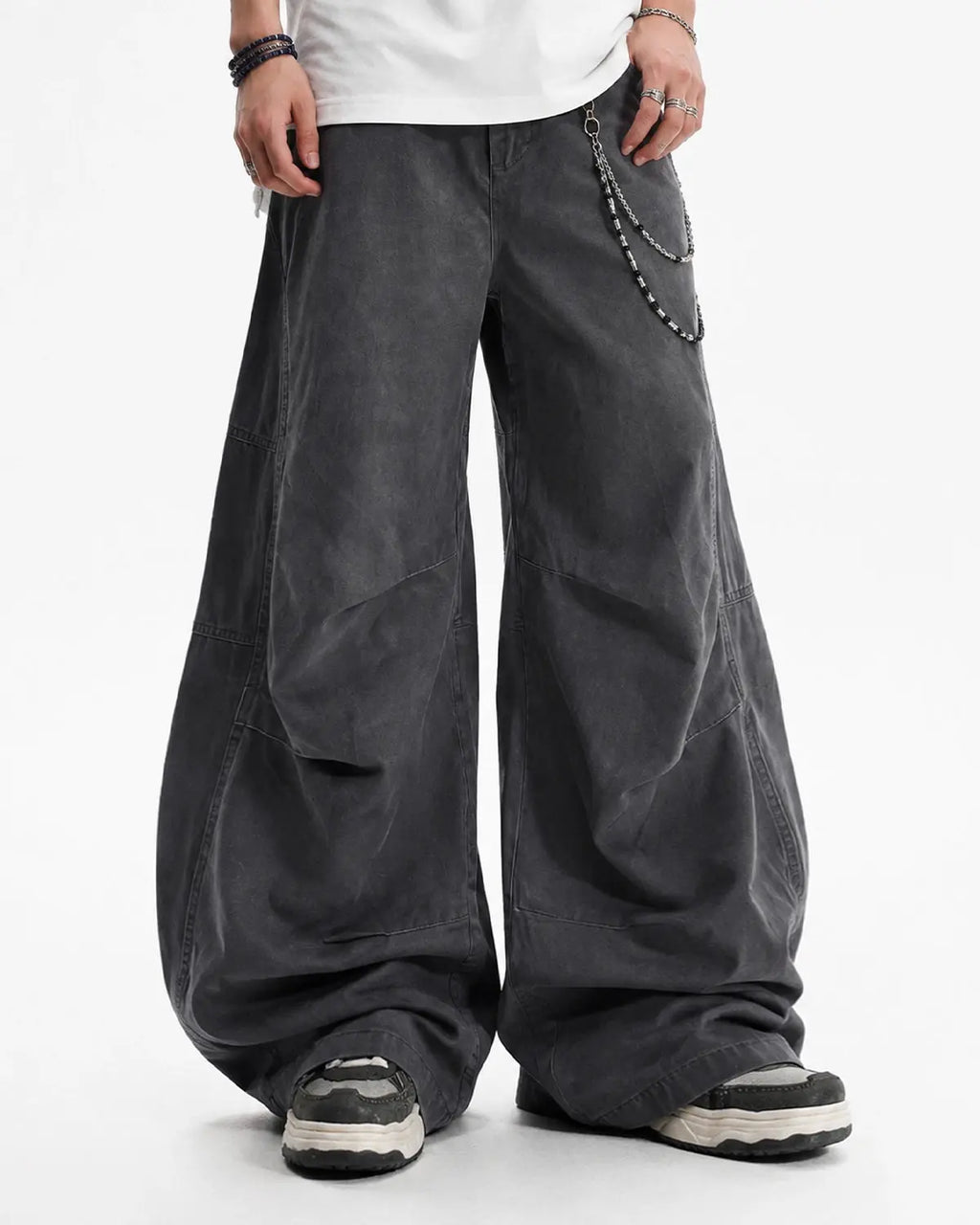 Washed curved seam cargo pants by INFLATION featuring a relaxed fit, multiple pockets, and distressed denim texture.