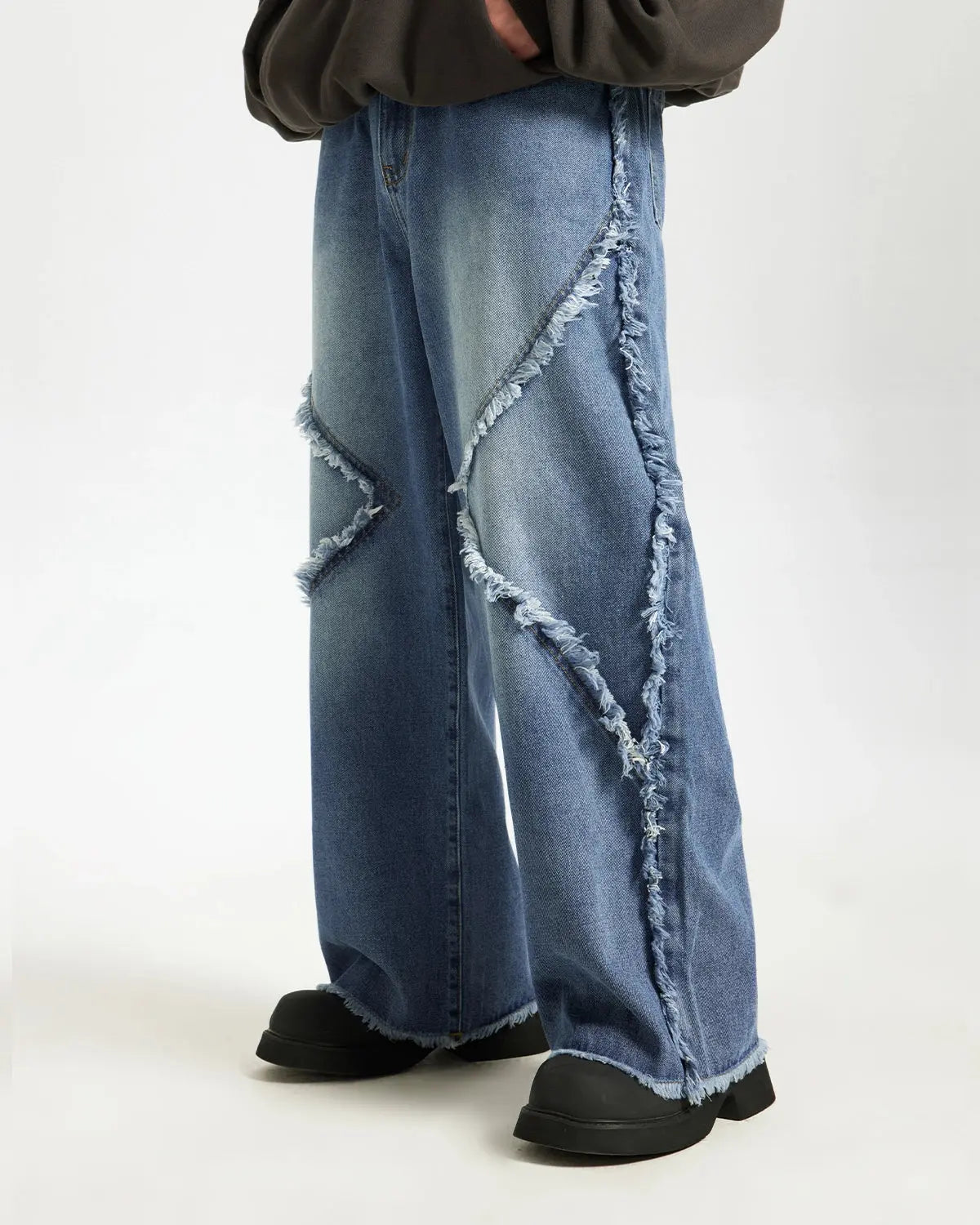 Blue frayed acid wash pants from Inflation Streetwear, showcasing distressed denim with frayed hems and relaxed fit.