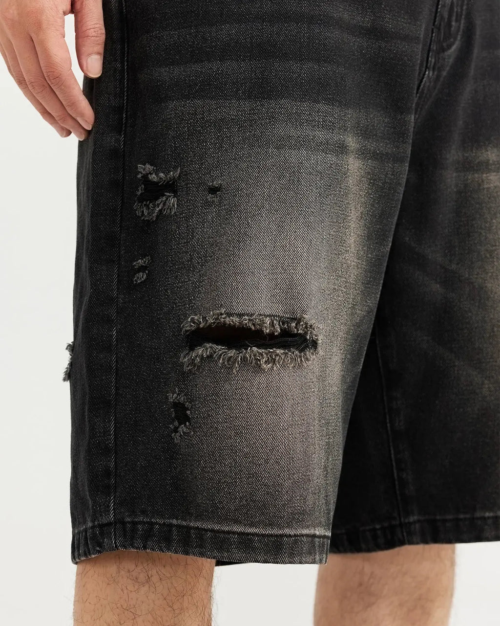 Vintage ripped washed jorts by Flation streetwear, showing distressed denim shorts with frayed edges and a casual fit.