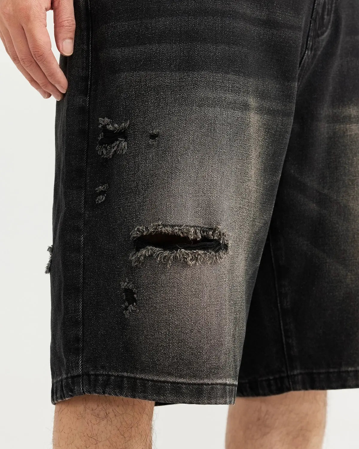 Vintage ripped washed jorts by Flation streetwear, showing distressed denim shorts with frayed edges and a casual fit.