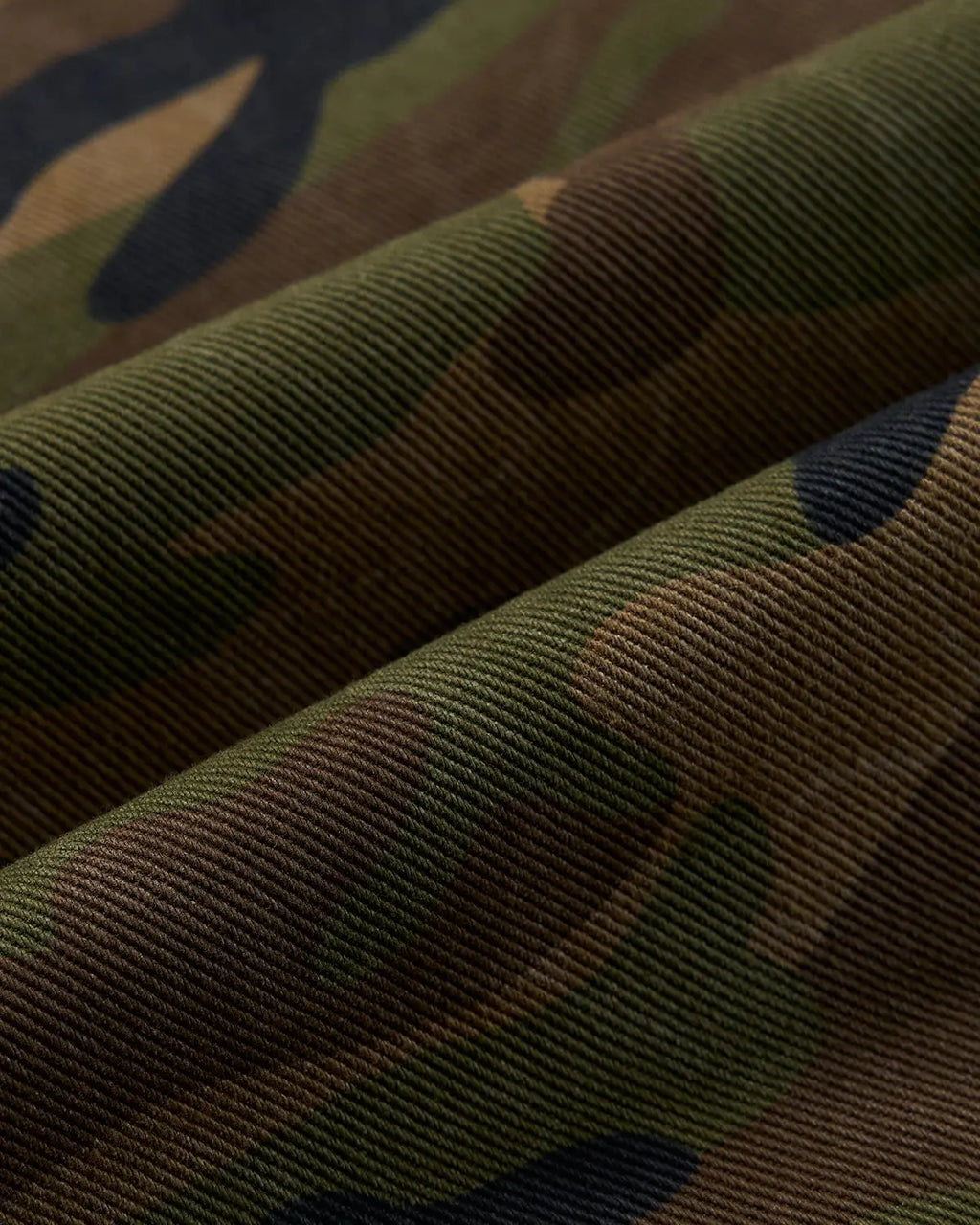 Metal clasp camo shorts by INFLATION, stylish streetwear pants with a camouflage pattern and metal clasp detail.