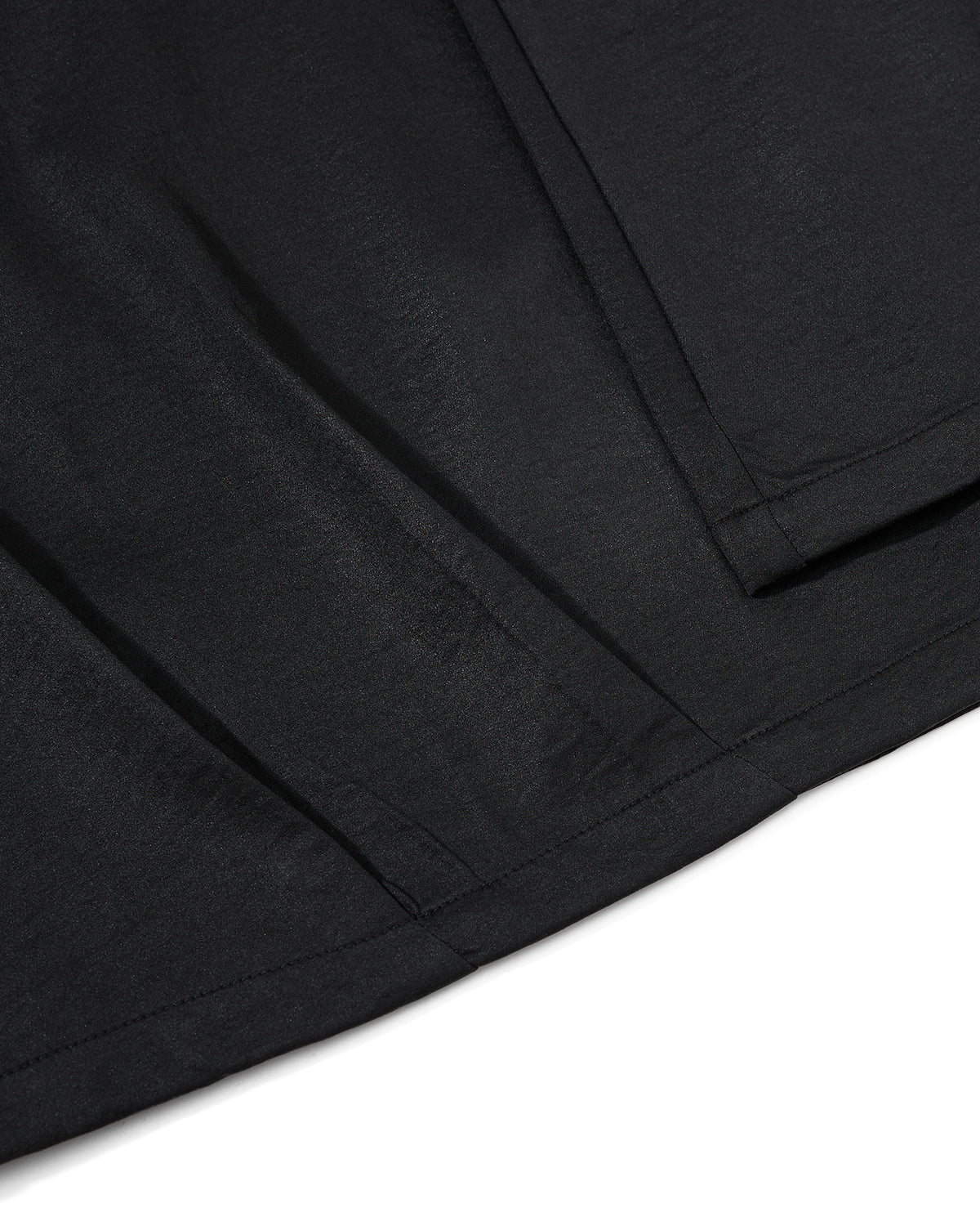 Black graphic wide-leg pants by INFLATION featuring bold patterns, loose fit, and streetwear style, shown on a model.