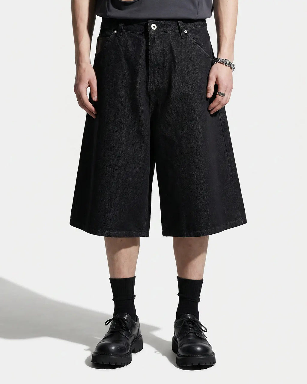 Inflation Streetwear longline wide-leg jorts pants with distressed denim and relaxed fit, displayed on a hanger.