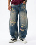 Distressed button barrel jeans by INFLATION featuring a relaxed fit and worn-in denim style, visible with distressed detailing and button closure.