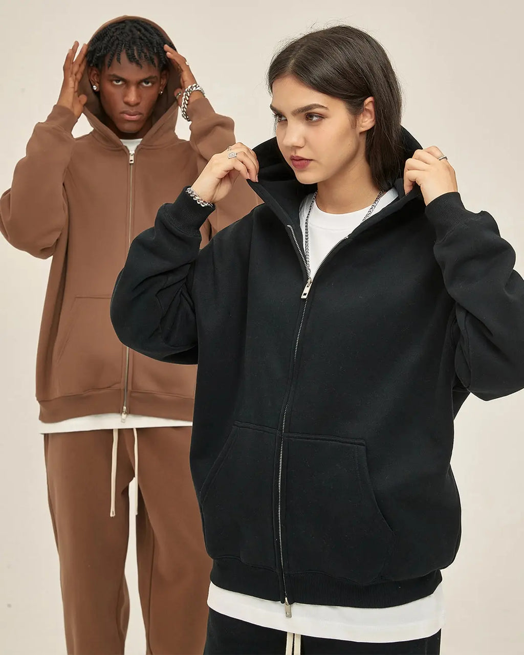 Black fleece double zip-up hoodie jacket by Flation, featuring a hood, front zipper, and cozy streetwear style.