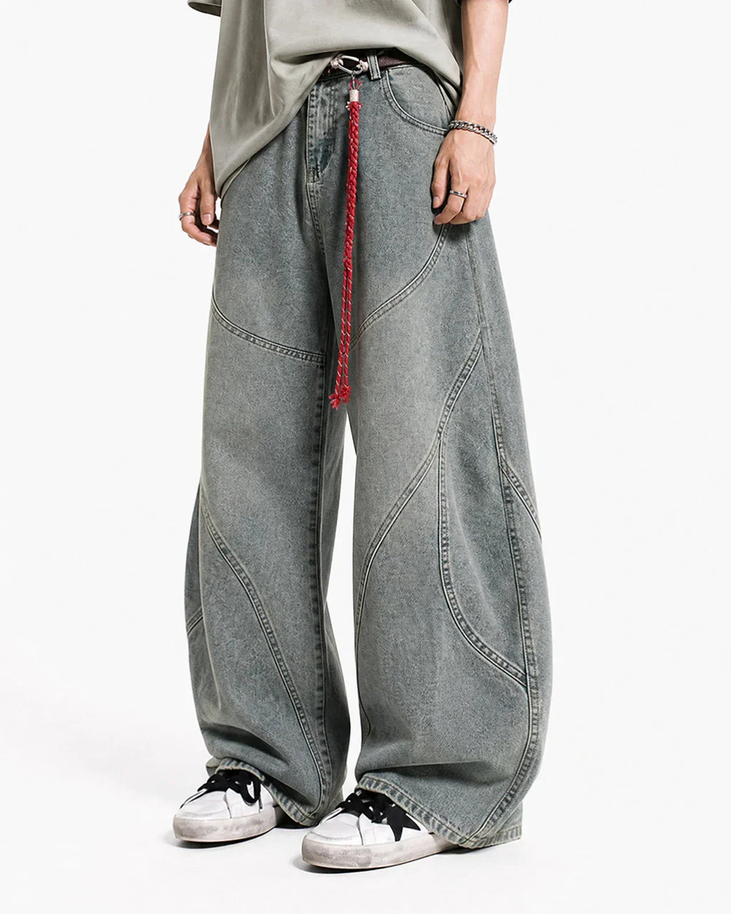 Acid wash baggy jeans with stitching detail from Flation Streetwear, featuring a relaxed fit and faded denim appearance.