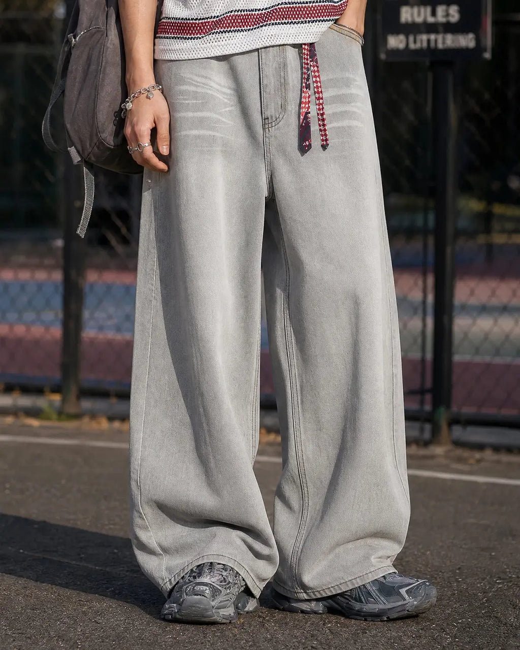 Washed distressed baggy jeans by Flation Streetwear with ripped details and relaxed fit, shown on a model.