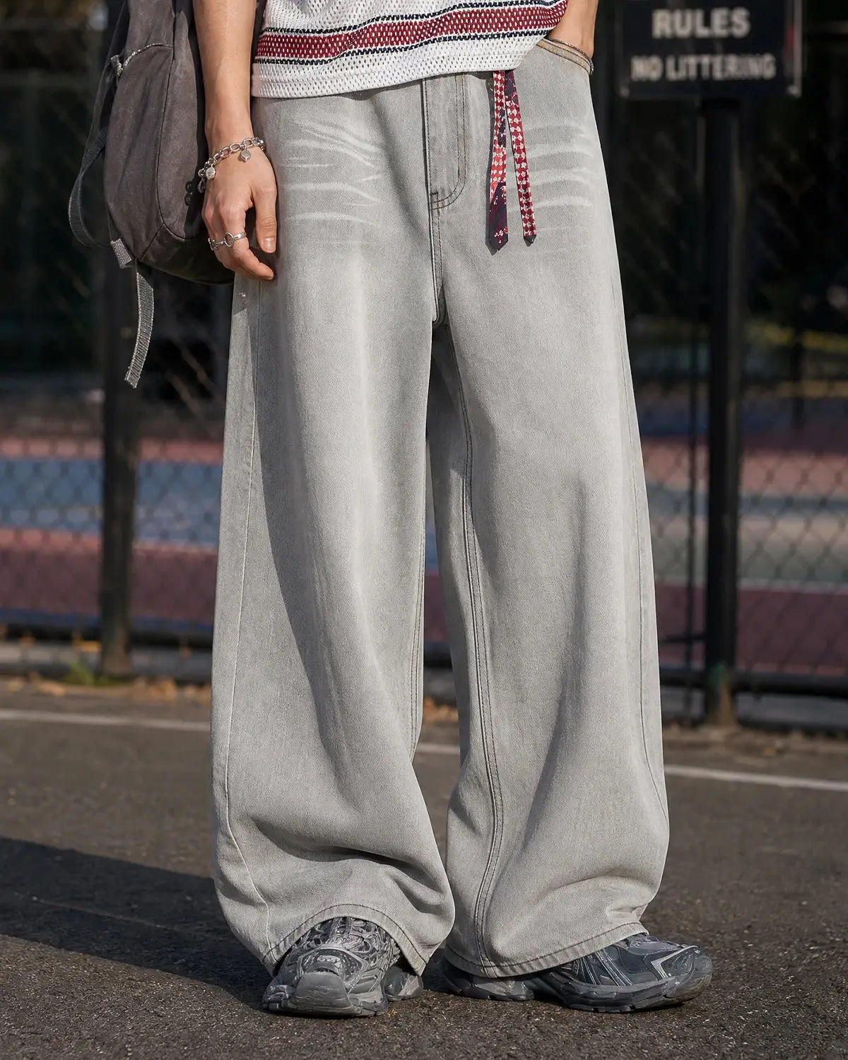 Washed distressed baggy jeans by Flation Streetwear with ripped details and relaxed fit, shown on a model.